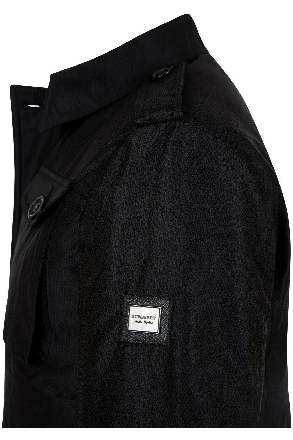 Close-up of black Burberry jacket shoulder with textured fabric and logo patch