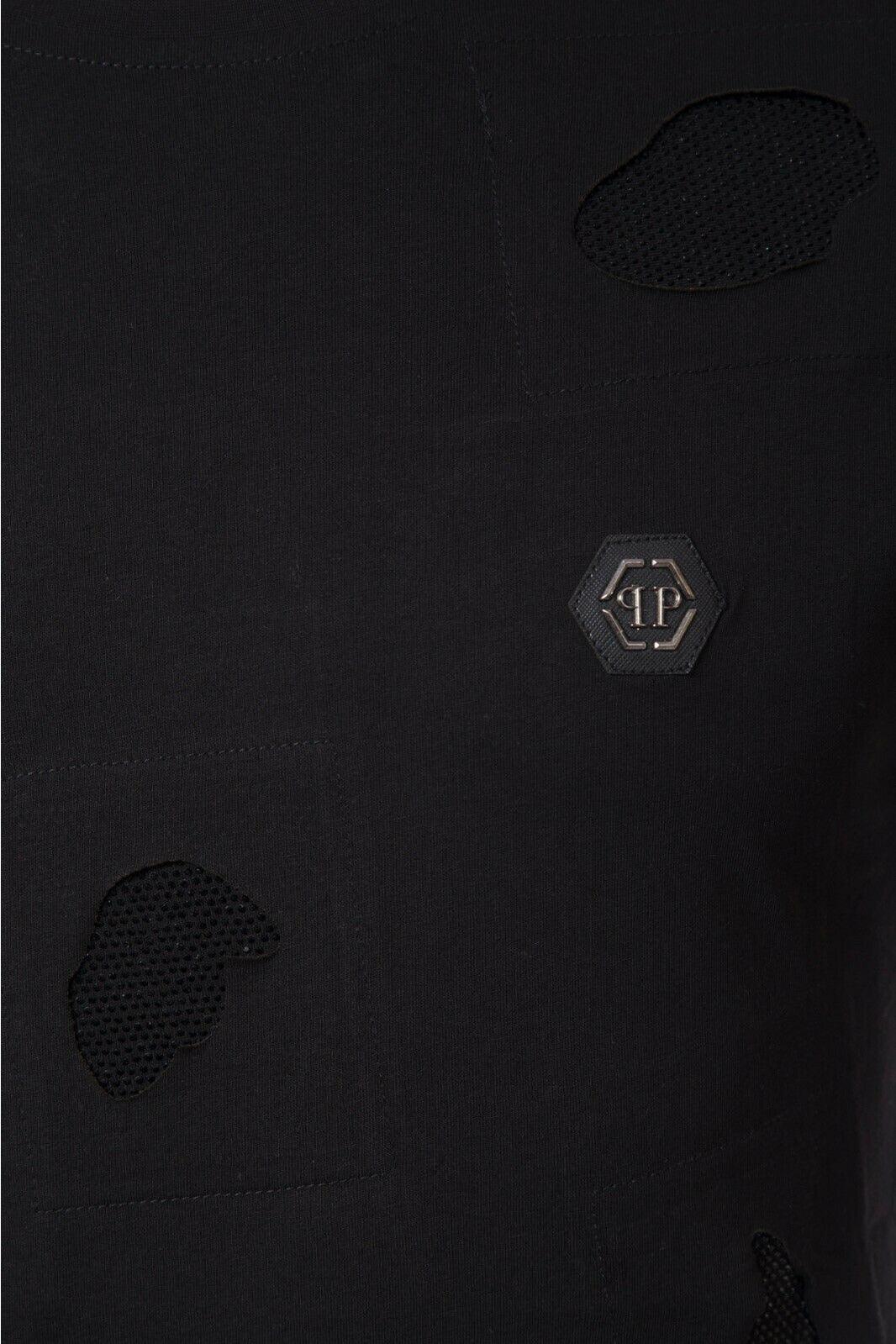 Black fabric with mesh patches and hexagonal metal logo emblem